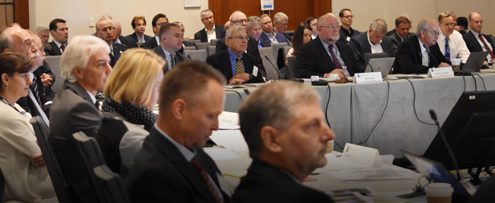 Chairman and co-chairs listening at head of table